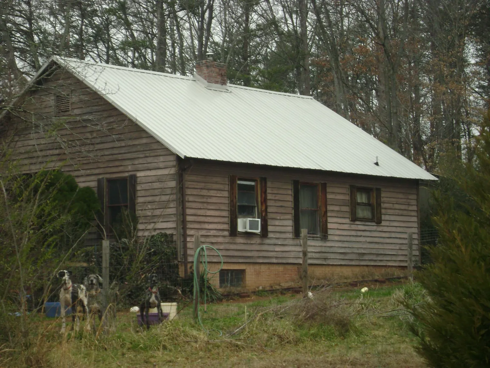 White metal roof on an old wood sided farmhouse, from a Metal Roof Installation job in Murrysville